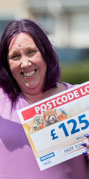 Helen Goodman pointing at her winning cheque